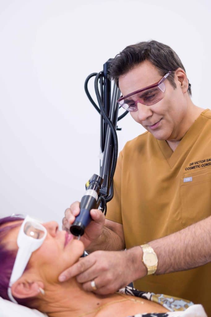 Dr Sagoo performing treatment with client