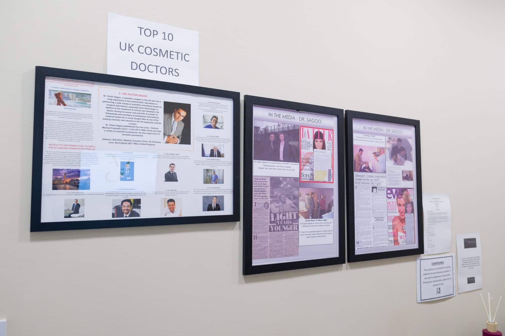 Framed wall display with newspaper clippings titled 'Top 10 UK Cosmetic Doctors'.